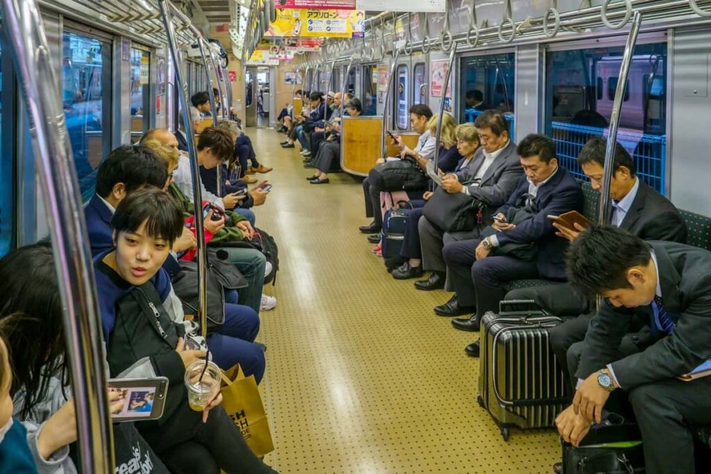 PEOPLE CHATTING ON A TRAIN IN JAPAN